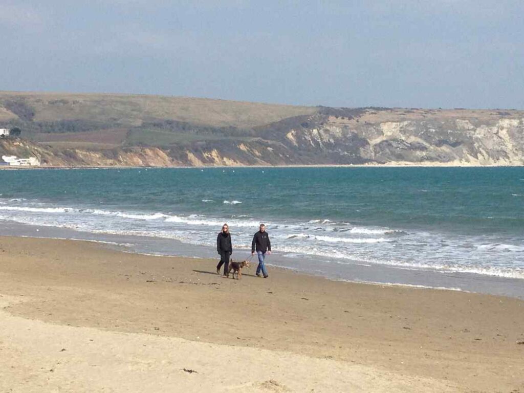 Winter walks with dog on Swanage Beach Dorset