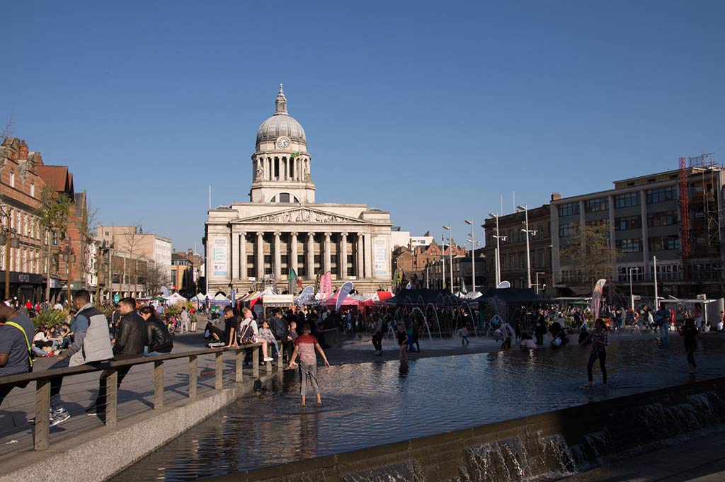 Crowds enjoy Old Market Square in Nottingham, with Nottingham Council House in the background